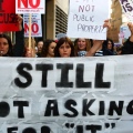 Women marching behind a "Still not Asking for 'It'" sign at Slutwalk Manchester