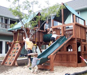 Kids on a playground surrounded by houses