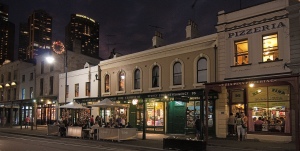 Photograph of George Street, The Rocks, at night, showing mostly well-kept pubs and restaurants