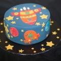 Cake decorated with a rocket ship and aliens