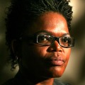 Head portrait of black woman with glasses.