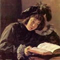 A 15th century painting of a boy reading, artist Frans Hals