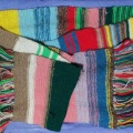 A very old and scraggly woollen scarf, knitted in rows of many colours a la Tom Baker, the 4th Doctor