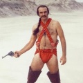 Sean Connery starring in the movie Zardoz. He is wearing some sort of orange nappy/bandolier with thigh-high black boots.