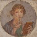 a fresco painting of a woman holding a tablet and a stylus