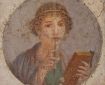 a fresco painting of a woman holding a tablet and a stylus